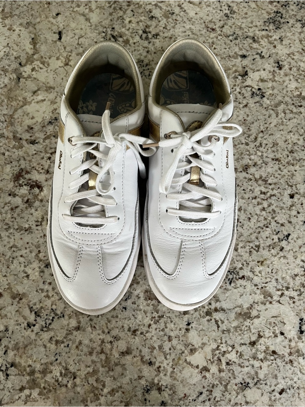 OluKai White and Gold Women's Sneakers